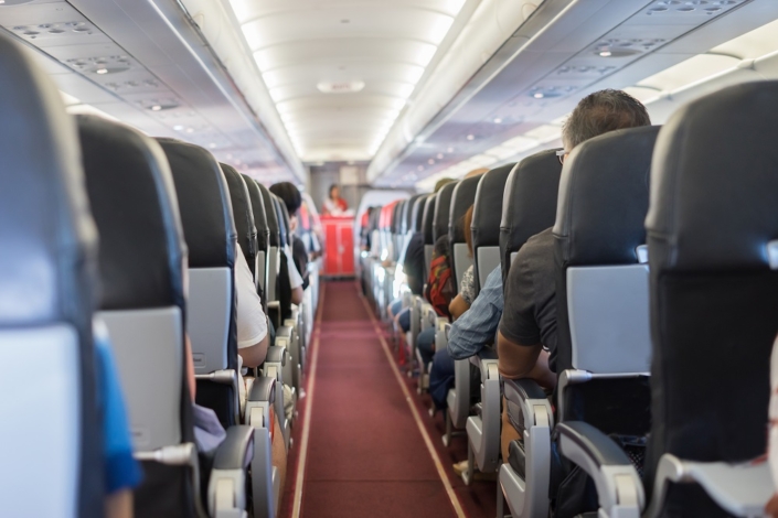 passenger seat, Interior of airplane with passengers sitting on